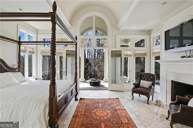 bedroom featuring lofted ceiling and a fireplace