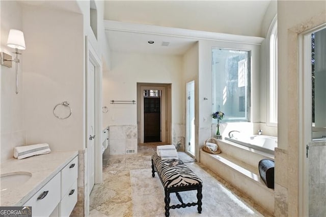 bathroom with vanity, a shower stall, and a bath