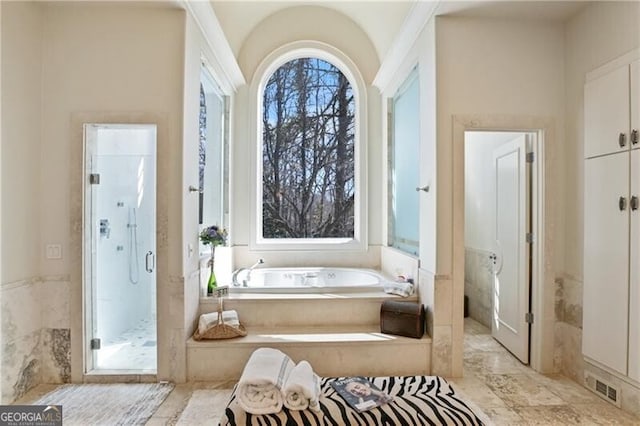 full bath featuring a garden tub, visible vents, and a shower stall