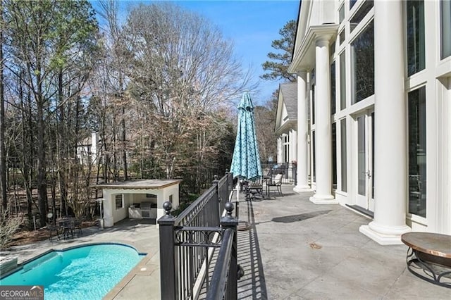 outdoor pool featuring a patio area and an outdoor structure