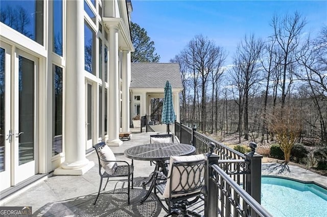 balcony featuring outdoor dining area, a patio, and french doors