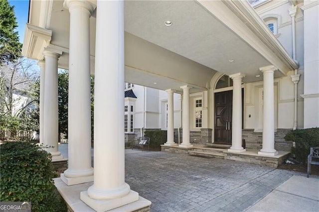 property entrance featuring stone siding