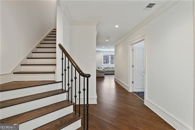 stairway featuring crown molding, recessed lighting, visible vents, wood finished floors, and baseboards