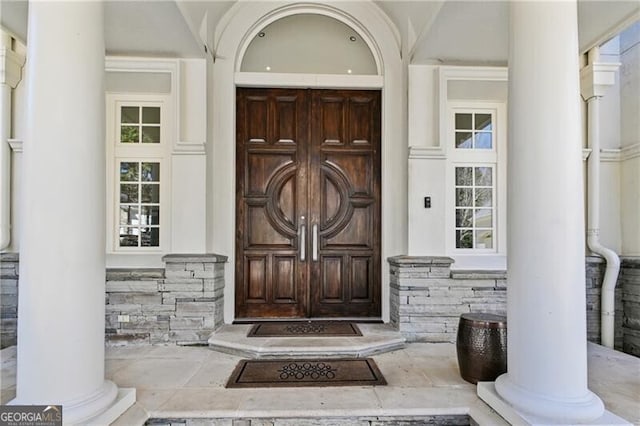 view of exterior entry featuring stone siding