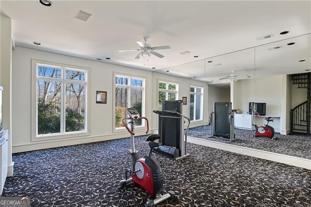 workout room featuring ceiling fan, carpet, and baseboards