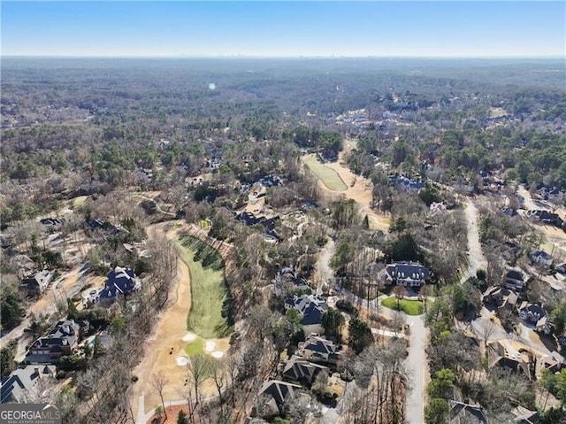 bird's eye view featuring a wooded view