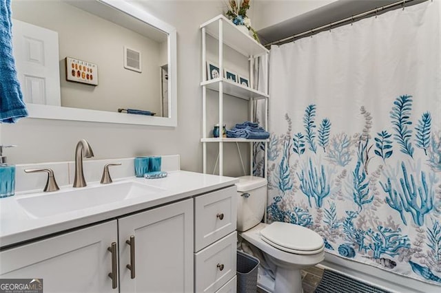 bathroom featuring visible vents, vanity, and toilet