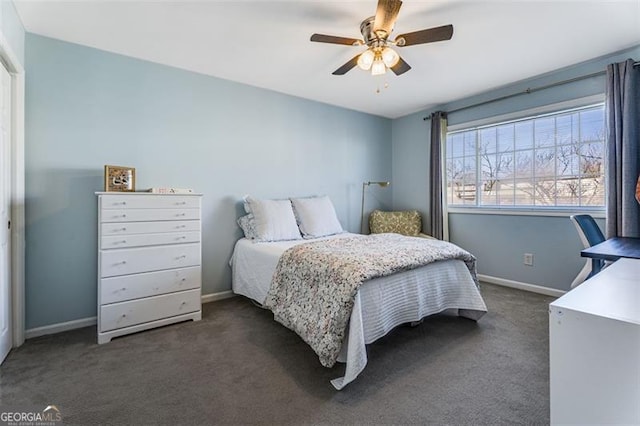 bedroom featuring ceiling fan, baseboards, and dark colored carpet