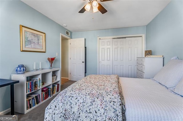 bedroom featuring baseboards, visible vents, ceiling fan, dark carpet, and a closet