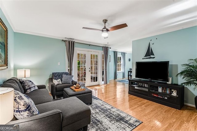 living room featuring ceiling fan, french doors, wood finished floors, and crown molding