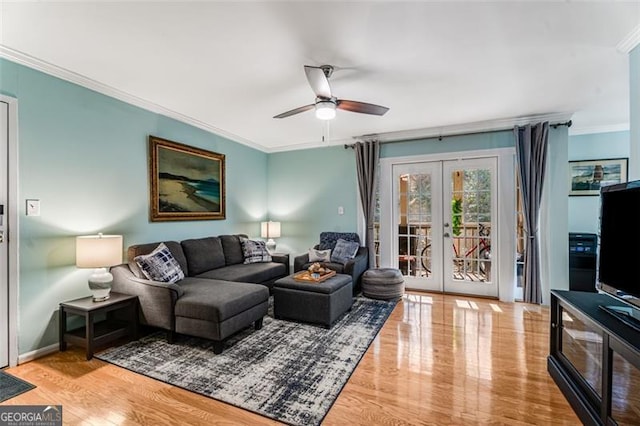 living room with baseboards, ceiling fan, crown molding, french doors, and light wood-style floors