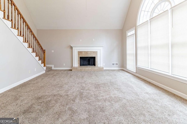 unfurnished living room with stairway, baseboards, visible vents, and carpet flooring