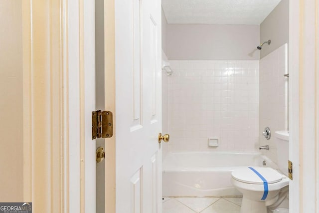 full bathroom with a textured ceiling, shower / tub combination, tile patterned flooring, and toilet