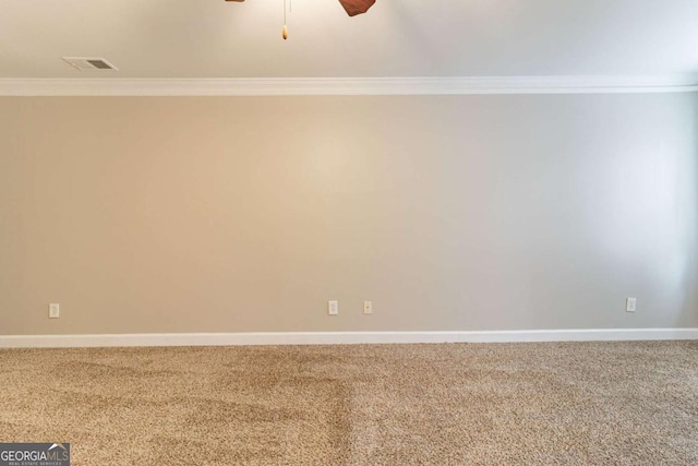 empty room featuring baseboards, ornamental molding, and carpet flooring