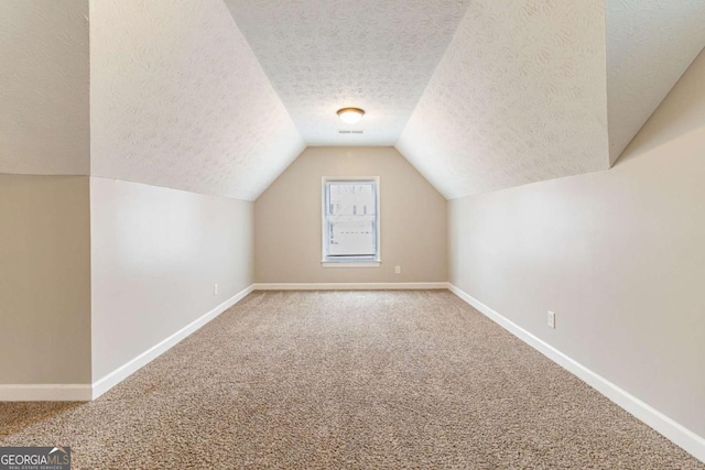 additional living space with carpet floors and baseboards