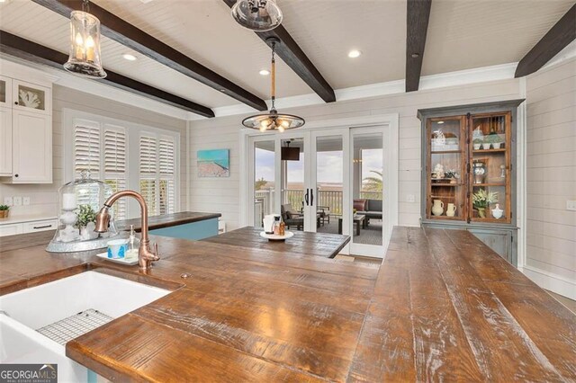 174 Bartram Way, Waverly, GA 31565 - kitchen with wood counters, a chandelier, healthy amount of natural light, beamed ceiling, and wooden walls