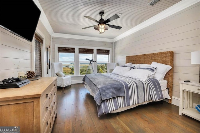 bedroom featuring wooden walls, dark wood-type flooring, and crown molding