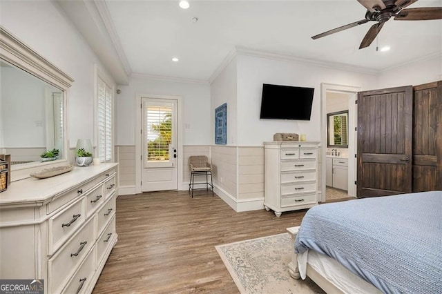 bedroom featuring crown molding, recessed lighting, a ceiling fan, wainscoting, and wood finished floors