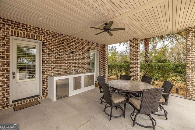 view of patio with a ceiling fan and outdoor dining space