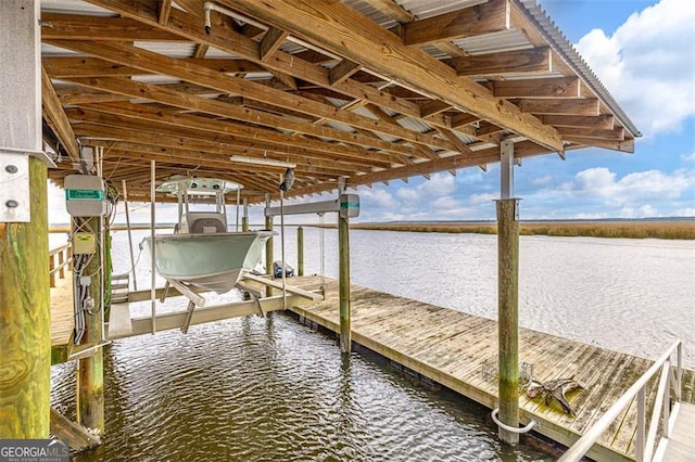 dock area with a water view and boat lift