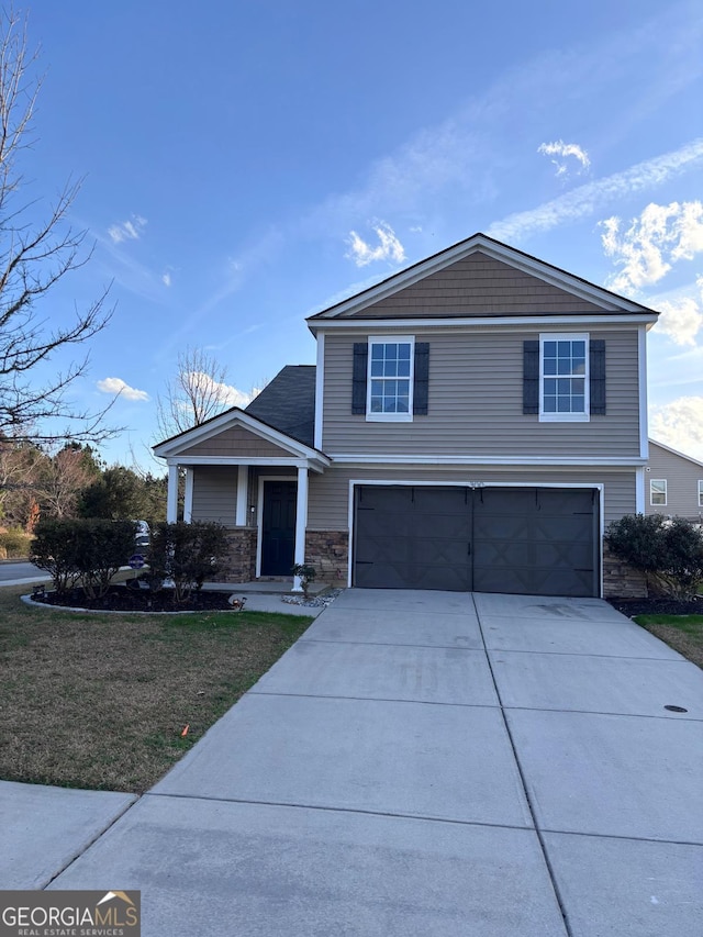 view of front of house with stone siding, concrete driveway, and an attached garage