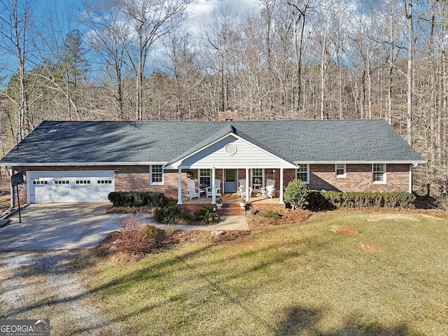 single story home featuring a garage, covered porch, a chimney, and a front lawn