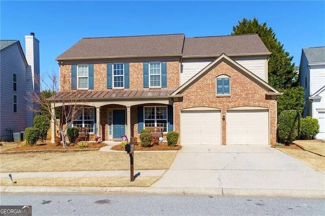 traditional-style home featuring covered porch, brick siding, concrete driveway, and central air condition unit