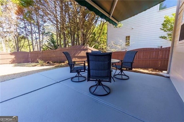 view of patio featuring outdoor dining space and a fenced backyard