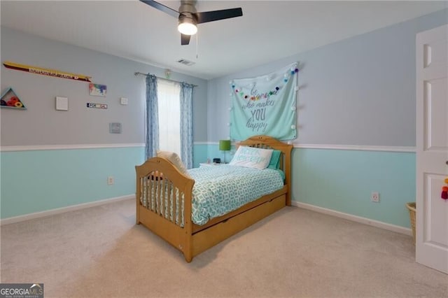 bedroom featuring light carpet, visible vents, baseboards, and a ceiling fan