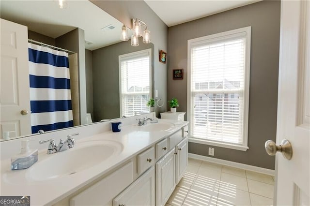 full bath featuring tile patterned flooring, a sink, visible vents, and baseboards