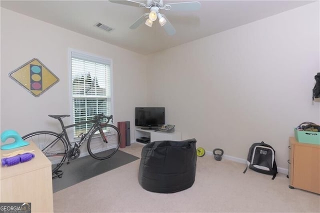 misc room with light colored carpet, visible vents, ceiling fan, and baseboards