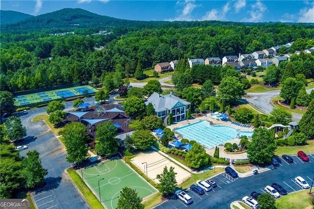 drone / aerial view with a wooded view