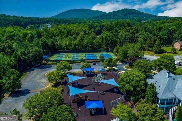 bird's eye view featuring a forest view and a mountain view