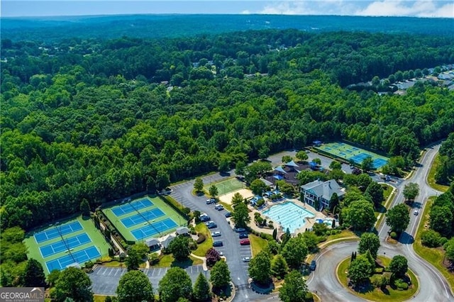 birds eye view of property with a forest view