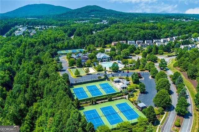 birds eye view of property with a forest view and a mountain view