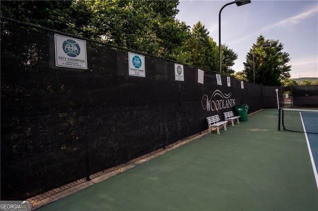 view of tennis court with fence