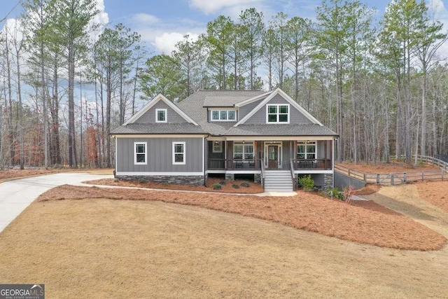 craftsman-style home with covered porch, a shingled roof, board and batten siding, and concrete driveway