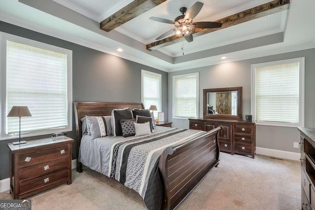 bedroom featuring baseboards, light colored carpet, a tray ceiling, crown molding, and beam ceiling