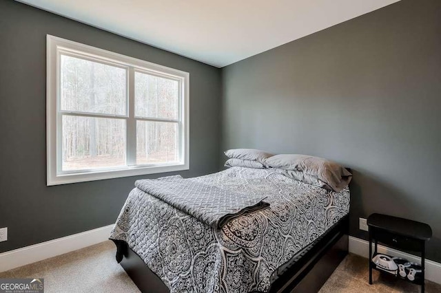 bedroom with carpet flooring and baseboards