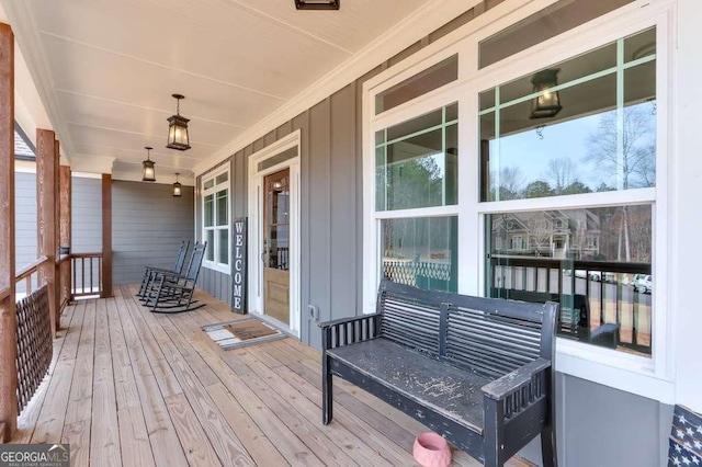 wooden terrace featuring covered porch