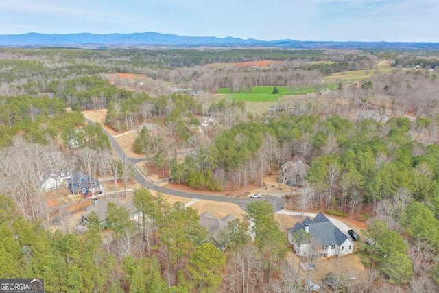 aerial view with a mountain view and a wooded view