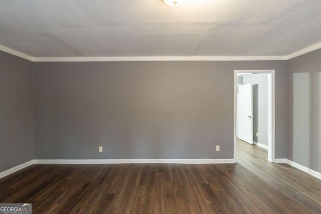 empty room featuring crown molding, baseboards, and dark wood-style flooring