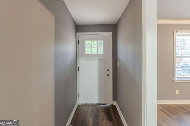 entryway with baseboards and wood finished floors