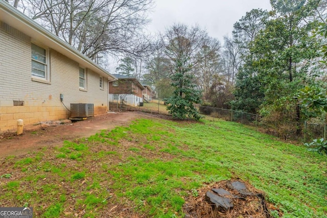 view of yard with a fenced backyard and central air condition unit