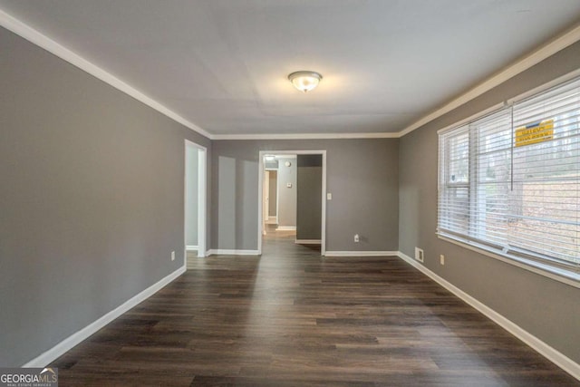 unfurnished room with baseboards, dark wood-type flooring, and ornamental molding