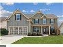 view of front of house featuring a garage, a front yard, and driveway