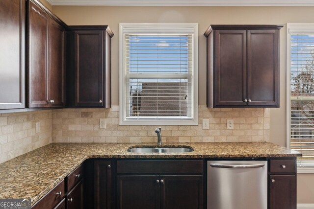 kitchen featuring light stone counters, dark brown cabinetry, a sink, backsplash, and dishwasher