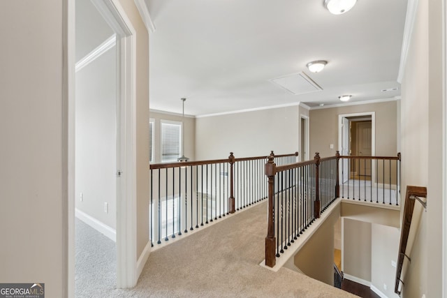 hall featuring an upstairs landing, baseboards, ornamental molding, and light colored carpet