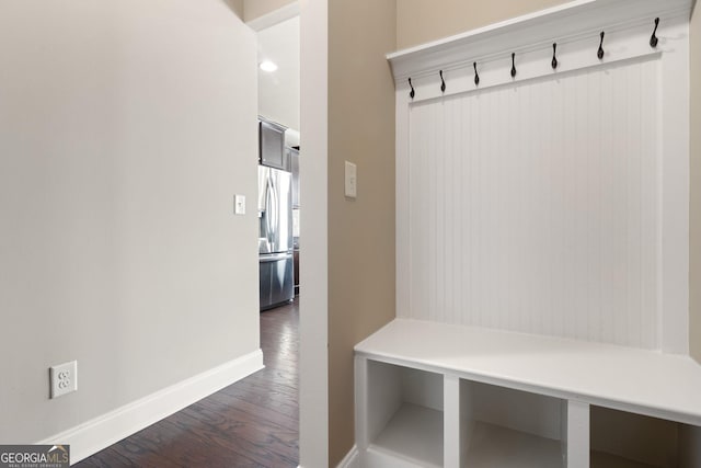 mudroom featuring dark wood-style floors and baseboards