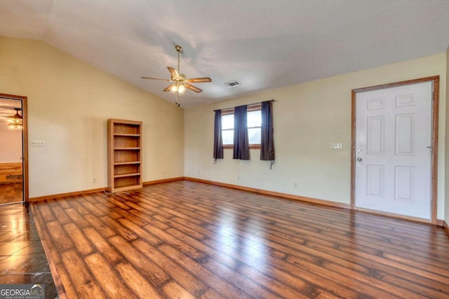 unfurnished living room with vaulted ceiling, ceiling fan, dark wood-type flooring, and visible vents